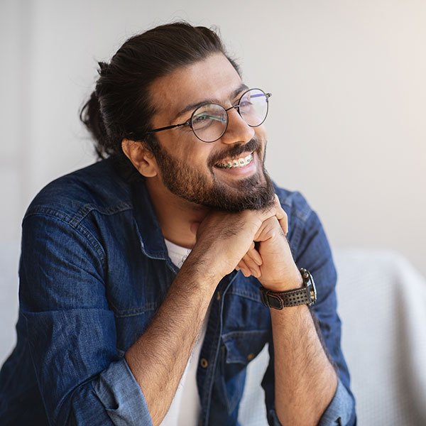Adult Orthodontics Man Smiling Indoors with Braces